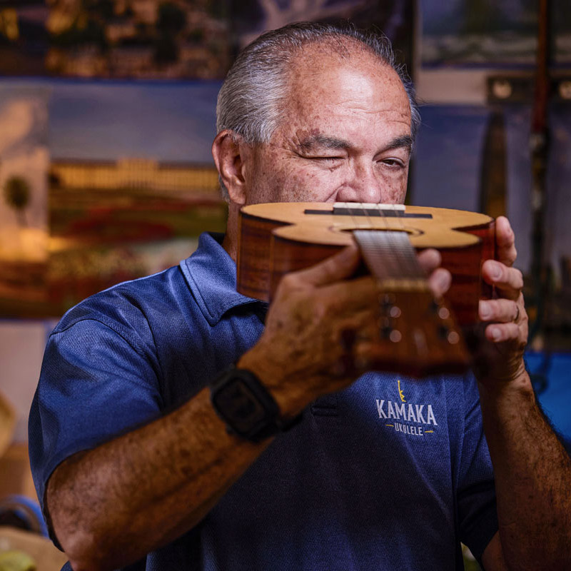 Chris Kamaka inspecting a finished ukulele